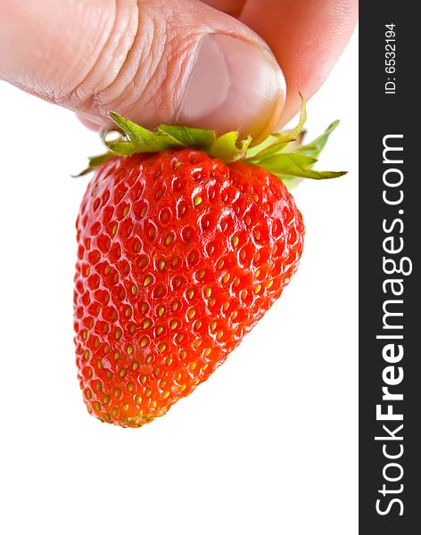 Hand holding a fresh strawberry