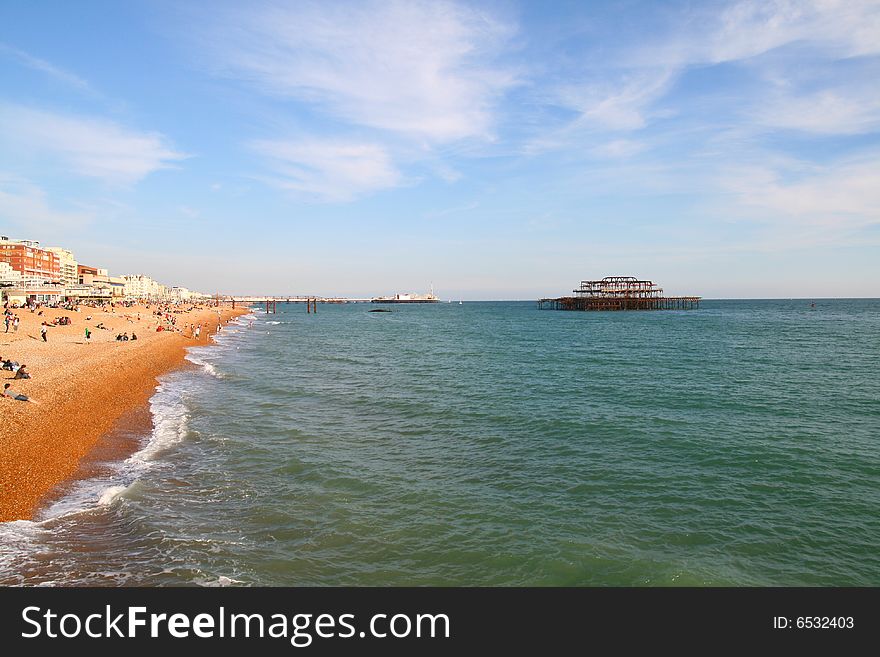 A wonderful view of the Brighton beach showing the old burned down pier in the distance