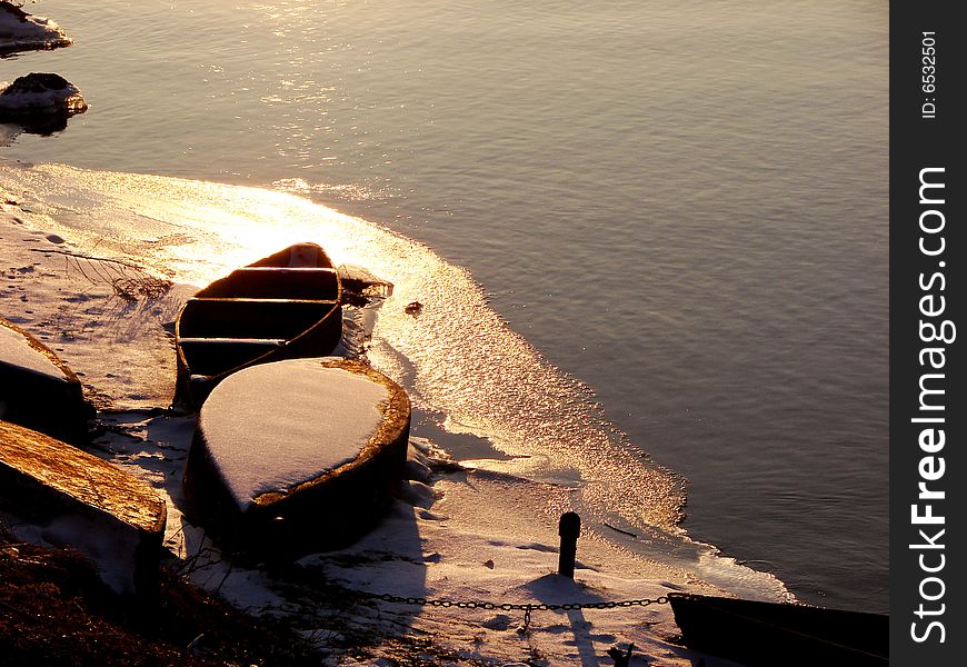 Boats near a bank on sunset of a sun