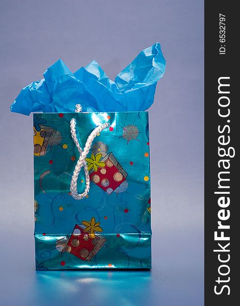 Blue gift bag with blue tissue paper.