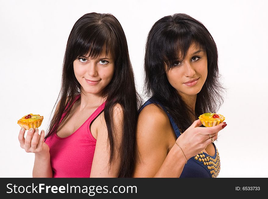 Two beautiful girls with cakes. Two beautiful girls with cakes