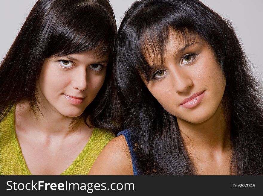 Two beautiful brunettes close up. Two beautiful brunettes close up