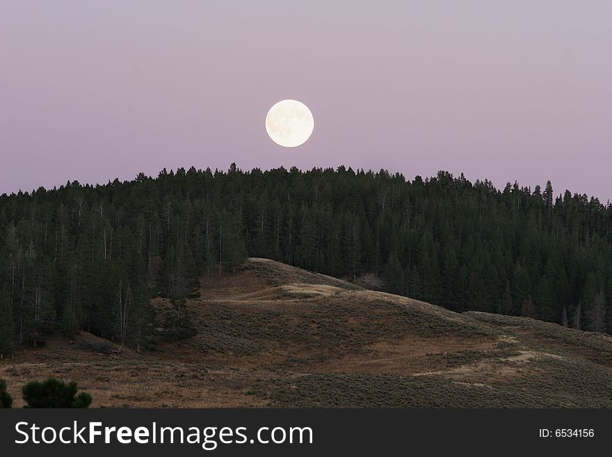 Full moon above the hills in Yellowstone park