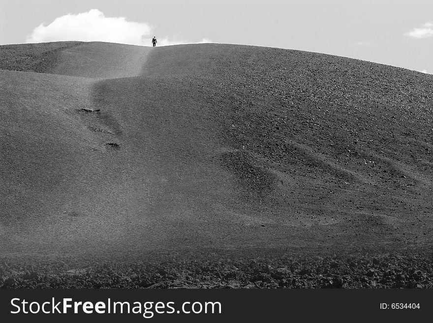 Lone figure on the top of the hill in black and white. Lone figure on the top of the hill in black and white