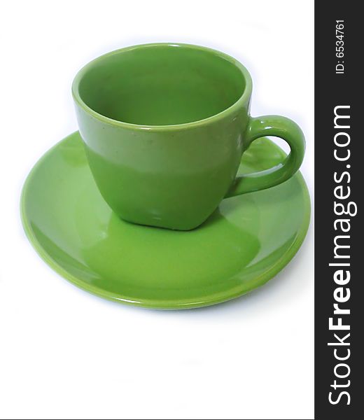 Green ceramic coffee cup on saucer, isolated, close-up. Green ceramic coffee cup on saucer, isolated, close-up