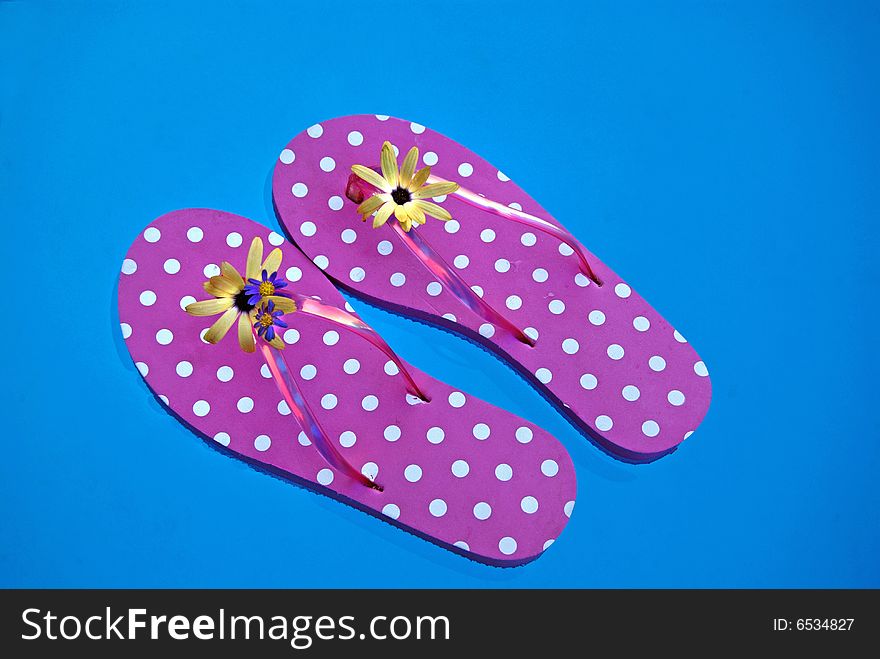 Fun flip-flops floating in the swimming pool. Fun flip-flops floating in the swimming pool.