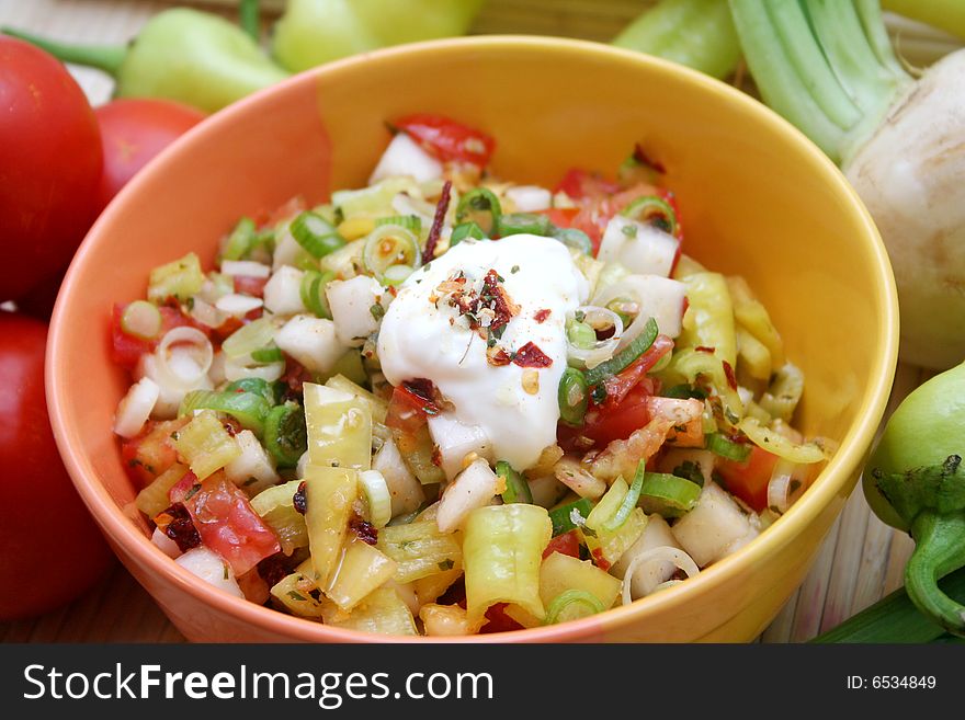 A fresh salad with peppers, onions and cream