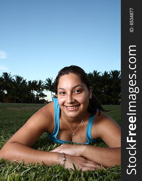 Young woman laying on grass