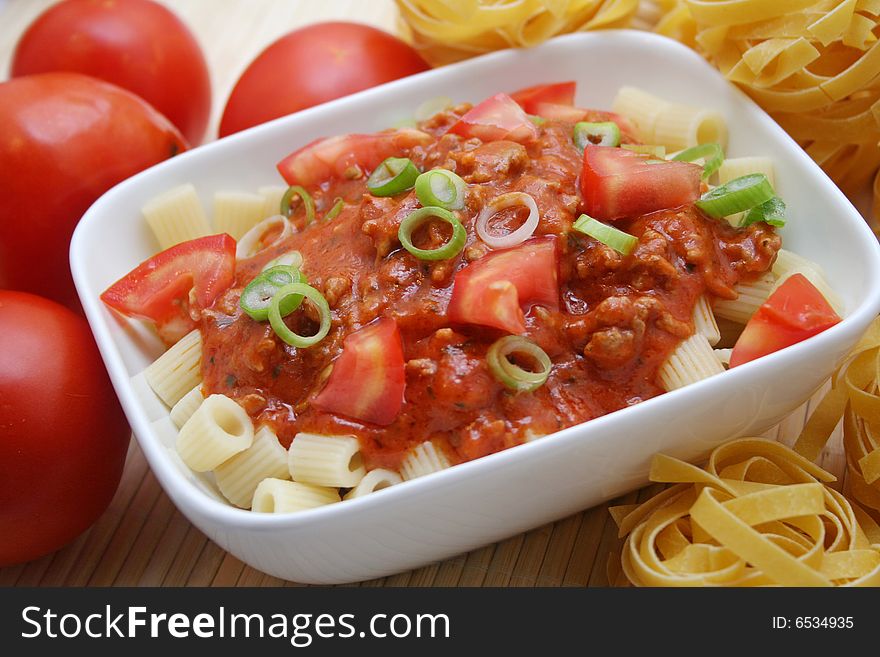 Fresh pasta with meat sauce and some tomatoes
