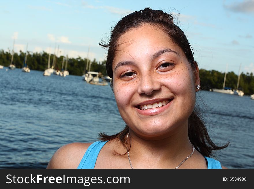 Head and shoulder shot of a young female smiling. Head and shoulder shot of a young female smiling.