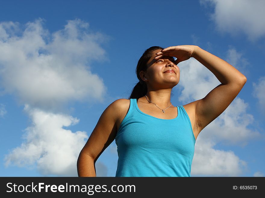 Young woman watching the sunset on a beautiful blue sky. Young woman watching the sunset on a beautiful blue sky.