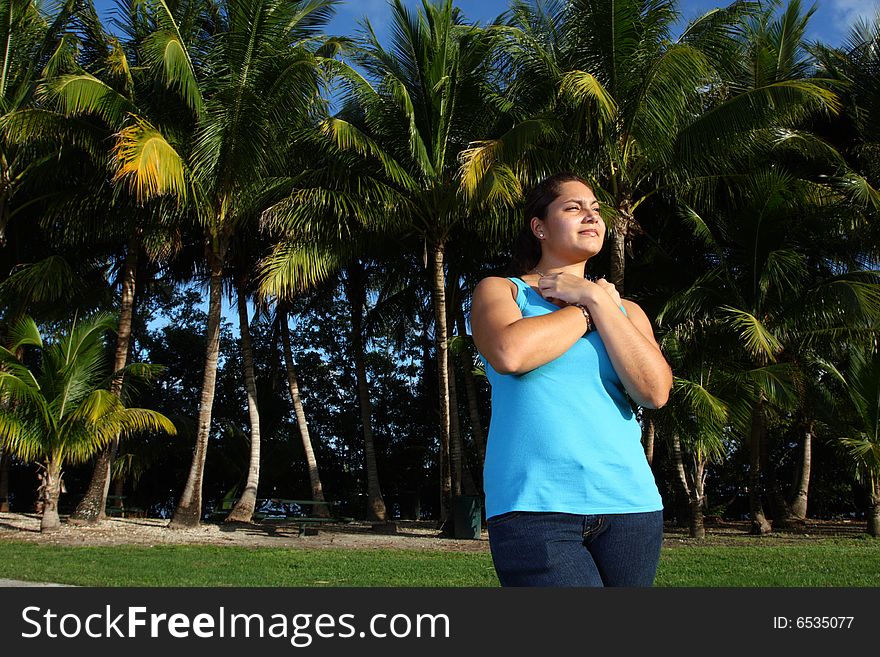 Young woman with palms in the background. Young woman with palms in the background