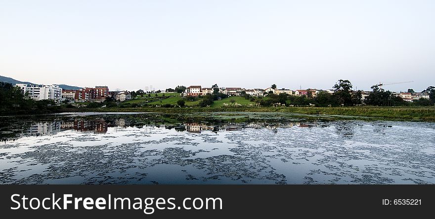 The reflection of that village on the river water. The reflection of that village on the river water