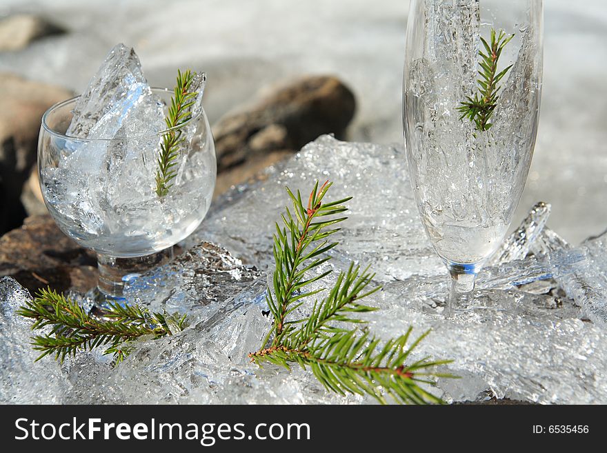 Glasses with ice on the edge of a frozen lake