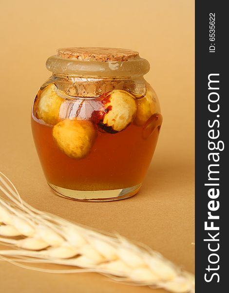 Container with honey and dry fruits and tenon of wheat