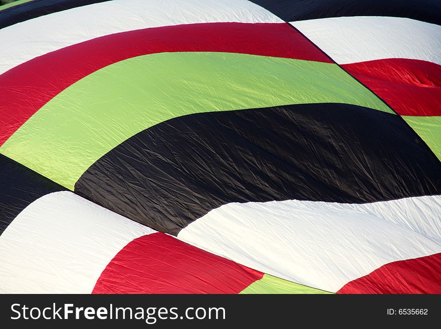 Closeup of a multi-colored hot air balloon being inflated