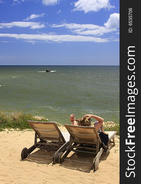 Woman relaxing on the top of the cliff