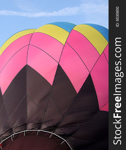 Closeup of a multi-colored hot air balloon being inflated