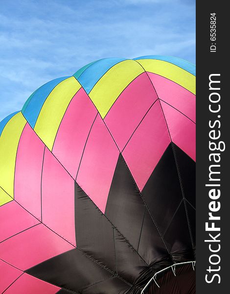 Closeup of a multi-colored hot air balloon being inflated