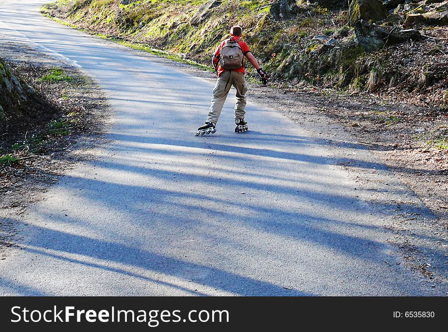 A man skating uphill in the mountains