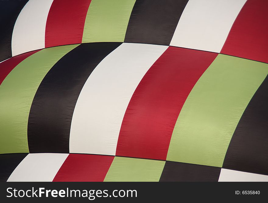 Closeup of a multi-colored hot air balloon being inflated