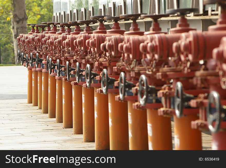 Some red fire hydrant on the ground.