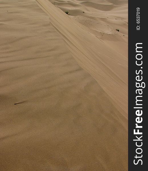 The sand of the dune flowing by wind, in Kumutage desert.