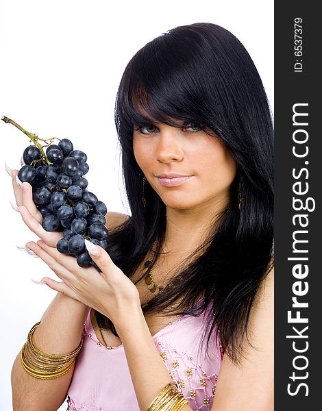 Young long hair brunette with bunch of black grapes. Young long hair brunette with bunch of black grapes