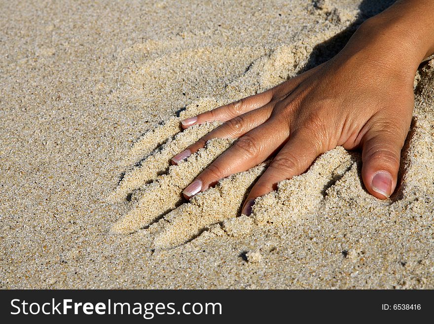 Hand to play in the sand. Hand to play in the sand