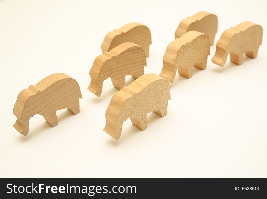 Against the background of the same faces several wooden elephants. Against the background of the same faces several wooden elephants