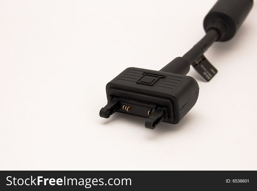 Black cellphone's cable isolated on white