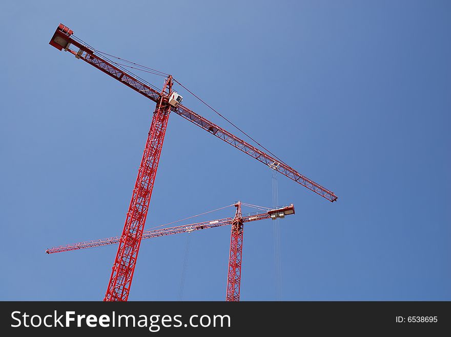 steel crane at a high rise building site. steel crane at a high rise building site