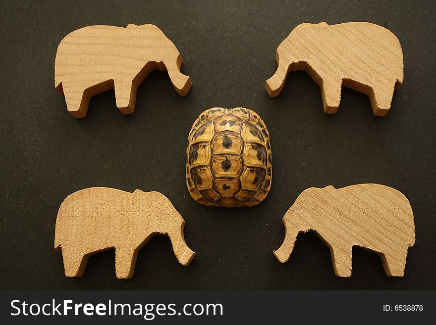 Against the background of the same faces several wooden elephants and skin of turtles. Against the background of the same faces several wooden elephants and skin of turtles