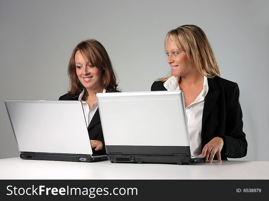 Two young woman with computers. Two young woman with computers