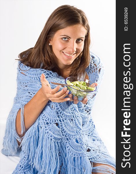 Portrait of young happy smiling woman eating salad