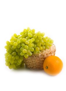Basket With Green Grapes And Beautiful Ripe Orange Royalty Free Stock Photography Basket With Green Grapes And Beautiful Ripe Orange Royalty Free Stock Photography