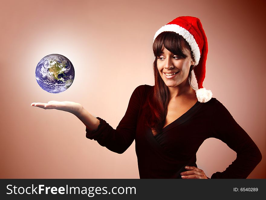 Woman with Santa Claus hat and a globe. Woman with Santa Claus hat and a globe