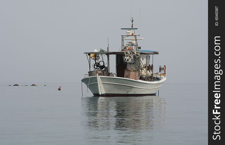 Fishermen's boat in the calm. Morning seascape. Fishermen's boat in the calm. Morning seascape.