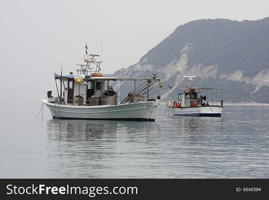 Two fishermen's boats anchored at the coastline. Morning seascape. Two fishermen's boats anchored at the coastline. Morning seascape.