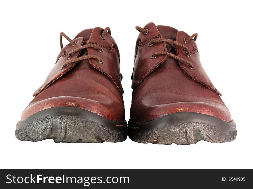 A pair of brown leather shoes from a low angle isolated on a white background