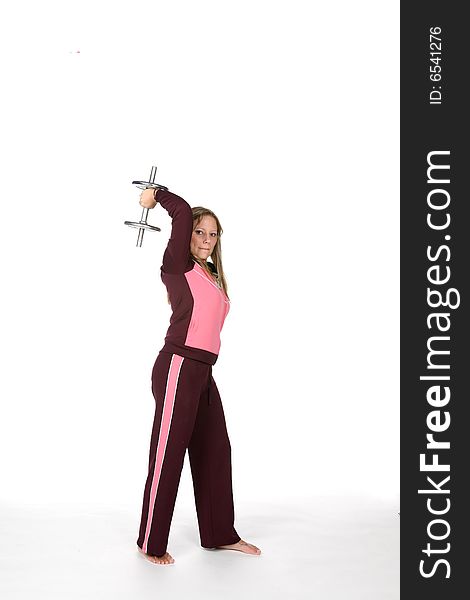 Pretty woman lifting heavy barbell over white background