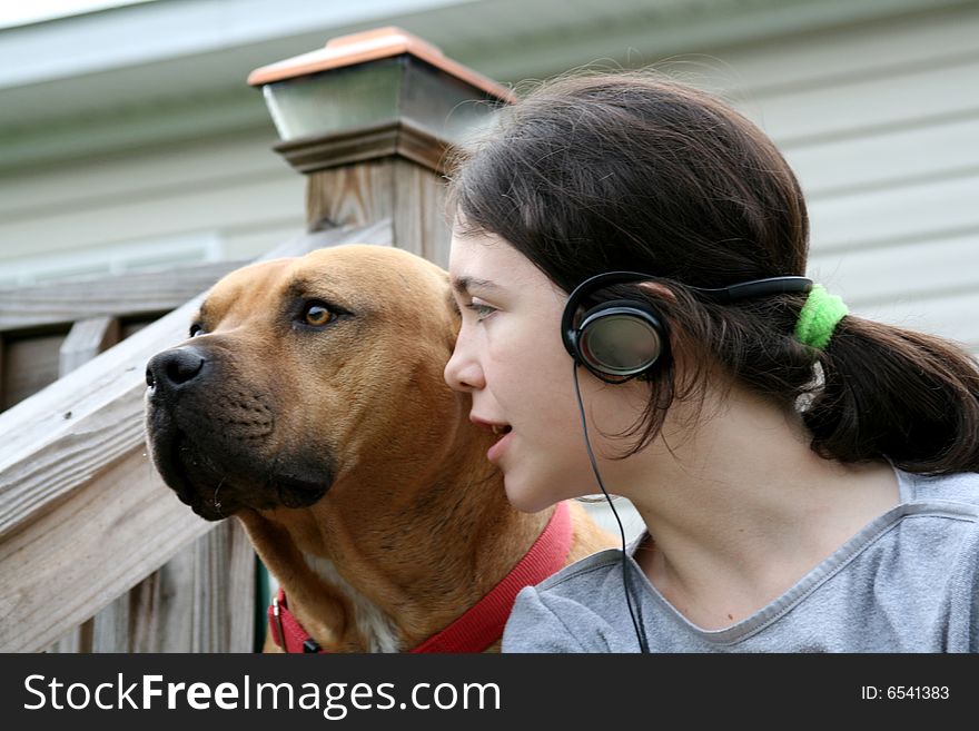 Girl and dog listening to music. Girl and dog listening to music