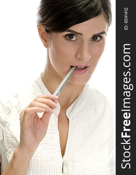 Lady with pen in her mouth on an isolated white background