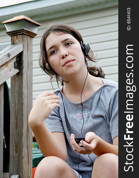 Teen girl listening  to mp3 player. Teen girl listening  to mp3 player