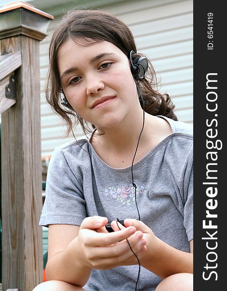 Teen girl listening  to mp3 player. Teen girl listening  to mp3 player