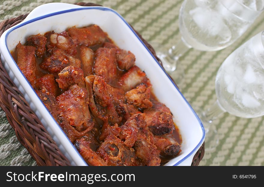 Oriental hot and spicy chili pork rib pieces with ice water. Oriental hot and spicy chili pork rib pieces with ice water