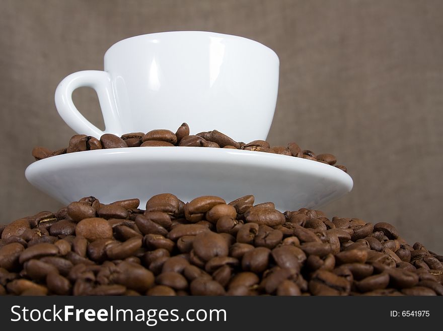 Cup of coffee over coffee beans