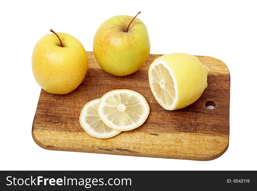 The apple cut by segments and lemon on a kitchen board. The apple cut by segments and lemon on a kitchen board