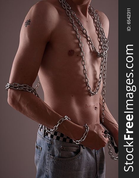 Closeup of man's body with hanging chain. Closeup of man's body with hanging chain