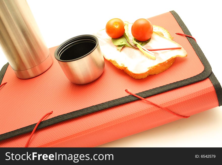 On a white background is a folder and food to eat on the move for example in construction. On a white background is a folder and food to eat on the move for example in construction